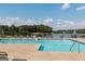 Community pool overlooking a lake with lounge chairs and tables, perfect for relaxation at 600 Lake Overlook Dr, Canton, GA 30114