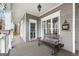 View of a covered porch featuring neutral paint, an outdoor bench and multiple large windows at 600 Lake Overlook Dr, Canton, GA 30114