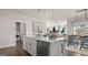 Kitchen with large island, stainless steel appliances, and adjacent dining area at 604 Parnassus Rd, Locust Grove, GA 30248