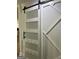Stylish white barn door with frosted glass panels and black hardware at 3132 Riders Trl, Decatur, GA 30034