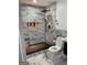 This bathroom features elegant marble-look tile in the shower and throughout at 3132 Riders Trl, Decatur, GA 30034
