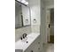 Bathroom with white vanity, black hardware, and marble-look tile at 3132 Riders Trl, Decatur, GA 30034
