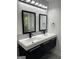 The modern bathroom features a double sink vanity with matte black fixtures and stylish lighting at 3132 Riders Trl, Decatur, GA 30034