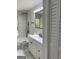 Modern bathroom with white vanity, marble-look tile, and a combined tub and shower at 3132 Riders Trl, Decatur, GA 30034