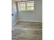 Bright bedroom featuring wood-look floors, neutral walls, and a double window offering natural light at 3132 Riders Trl, Decatur, GA 30034