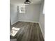 An empty bedroom with wood flooring, white trim, and natural light from two windows at 3132 Riders Trl, Decatur, GA 30034