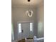 Elegant entryway featuring a modern light fixture, white walls, and an inviting entrance door with sidelights at 3132 Riders Trl, Decatur, GA 30034