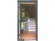 View of the entryway featuring hardwood floors, white stairs, and a barn door on the upper level at 3132 Riders Trl, Decatur, GA 30034