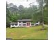 Charming exterior of home with a bright red front door and well-maintained landscaping at 3132 Riders Trl, Decatur, GA 30034