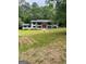 Lovely front exterior with green lawn, mature trees and a charming brick home at 3132 Riders Trl, Decatur, GA 30034