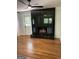 Fireplace in a room with hardwood floors, black tile surround, and a view of the outside at 3132 Riders Trl, Decatur, GA 30034