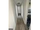 Bright hallway showcasing wood-look floors and access to a renovated bathroom in a modern home at 3132 Riders Trl, Decatur, GA 30034