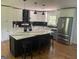 Bright kitchen with white cabinets, black accents, hardwood floors, and stainless steel appliances at 3132 Riders Trl, Decatur, GA 30034