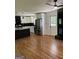 Modern kitchen featuring stainless steel appliances, black backsplash, white cabinetry, and hardwood floors at 3132 Riders Trl, Decatur, GA 30034