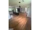 Open living area featuring a large kitchen island, fireplace, hardwood floors, and modern lighting at 3132 Riders Trl, Decatur, GA 30034