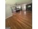 Large open living area featuring hardwood floors and views of the kitchen and fireplace at 3132 Riders Trl, Decatur, GA 30034