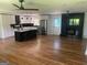 Open-concept living room and kitchen area with hardwood floors and a fireplace at 3132 Riders Trl, Decatur, GA 30034