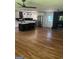 Spacious living room with hardwood floors, an open layout, and modern kitchen appliances at 3132 Riders Trl, Decatur, GA 30034