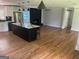 Spacious living room featuring hardwood floors, a fireplace, and a kitchen island at 3132 Riders Trl, Decatur, GA 30034