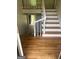 Well-lit staircase with hardwood steps, white risers, and a white banister leading to the upper level at 3132 Riders Trl, Decatur, GA 30034