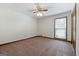 Carpeted bedroom featuring a window with blinds, ceiling fan with light, and wooden trim at 41 Ridgewood Cir, Mcdonough, GA 30252