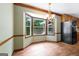 Dining area features a bay window offering natural light, chandelier, and wood floors at 41 Ridgewood Cir, Mcdonough, GA 30252