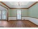 Formal dining room with unique ceiling detail, wainscotting, and wood floors at 41 Ridgewood Cir, Mcdonough, GA 30252