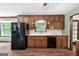 Classic kitchen with wood cabinets, white countertops, and black appliances at 41 Ridgewood Cir, Mcdonough, GA 30252