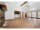 Cozy living room featuring a stone fireplace, vaulted ceiling, and wood-look flooring at 41 Ridgewood Cir, Mcdonough, GA 30252