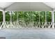 Inviting screened porch with wood plank flooring and lattice details overlooking the green backyard at 41 Ridgewood Cir, Mcdonough, GA 30252