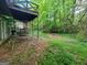 Backyard featuring a deck with stairs, grass, and lush greenery at 4060 Sumit Wood Nw Dr, Kennesaw, GA 30152