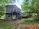 Two-story home with a back deck and staircase, nestled in a wooded lot at 4060 Sumit Wood Nw Dr, Kennesaw, GA 30152