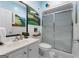 Bathroom featuring a patterned floor, a vanity, a toilet, and a shower with a sliding door and landscape mural at 130 Allie Drive, Mcdonough, GA 30252