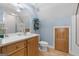 Bathroom featuring a wood vanity, tile flooring, a shower stall, and a toilet at 130 Allie Drive, Mcdonough, GA 30252