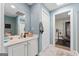 Well-lit bathroom featuring a vanity, and an adjacent exercise room at 130 Allie Drive, Mcdonough, GA 30252