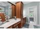 Bathroom featuring a vanity with good storage, a makeup mirror, a window, and an adjoining room at 130 Allie Drive, Mcdonough, GA 30252