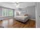Bright bedroom with hardwood floors, natural light, ceiling fan, and neutral decor at 130 Allie Drive, Mcdonough, GA 30252