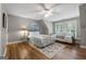 Bedroom with hardwood floors, ceiling fan, a queen bed and a twin bed next to a set of windows at 130 Allie Drive, Mcdonough, GA 30252