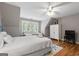 Bedroom featuring hardwood floors, ceiling fan, a queen bed and a twin bed next to a set of windows at 130 Allie Drive, Mcdonough, GA 30252