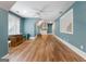Open and airy bonus room with hardwood floors, large windows, a ceiling fan and custom built in shelving at 130 Allie Drive, Mcdonough, GA 30252