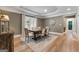 Elegant dining room featuring hardwood floors, a decorative rug, and a classic table with seating for six at 130 Allie Drive, Mcdonough, GA 30252