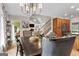 Open dining room and kitchen layout, featuring a view of the living room and staircase at 130 Allie Drive, Mcdonough, GA 30252