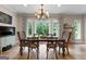 Dining room featuring a chandelier, large windows, and a view of the serene backyard at 130 Allie Drive, Mcdonough, GA 30252