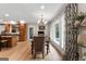Dining area with wood floors, decorative curtains, and views to the outdoor swimming pool at 130 Allie Drive, Mcdonough, GA 30252
