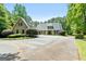Charming stone home with a circular driveway and manicured landscaping, offering elegance and privacy at 130 Allie Drive, Mcdonough, GA 30252