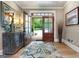 Warm foyer with a decorative rug, wooden flooring, and a stylish buffet, welcoming guests into the home at 130 Allie Drive, Mcdonough, GA 30252