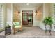 Inviting foyer featuring brick flooring, a wooden front door, and stylish decor, with a glimpse into the living area at 130 Allie Drive, Mcdonough, GA 30252