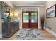 Welcoming foyer features a patterned rug, wooden floors, and stylish decor, leading into a bright and airy home at 130 Allie Drive, Mcdonough, GA 30252