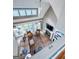 Open-concept living room with soaring ceilings, fireplace, hardwood floors, and ample natural light at 130 Allie Drive, Mcdonough, GA 30252