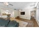 Relaxing living room with hardwood flooring, a ceiling fan, and access to a kitchen and bedroom at 130 Allie Drive, Mcdonough, GA 30252